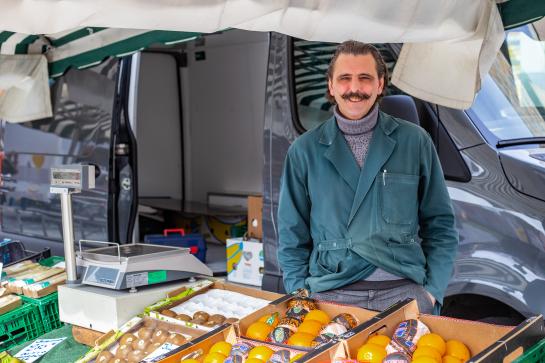 Illustratieve foto van man bij een fruitkraam op de markt